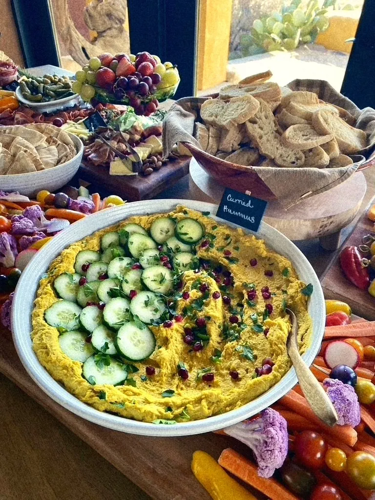 Curried hummus with cucumber and pomegranate, crudité alongside