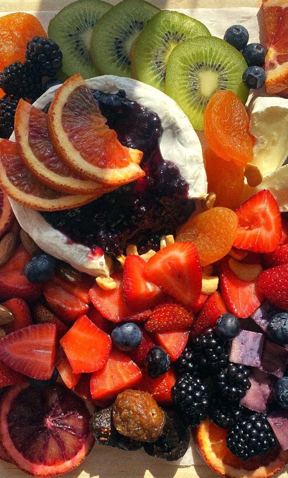Brie with blueberry jam, blood orange, kiwi, strawberries and dried apricots