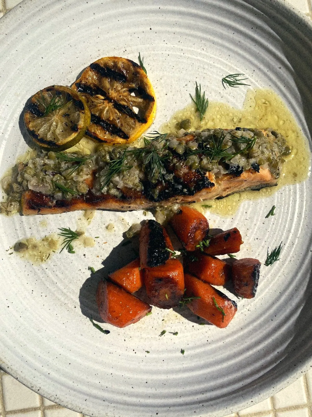 Seared salmon with grilled lemon, roasted carrots and salsa verde