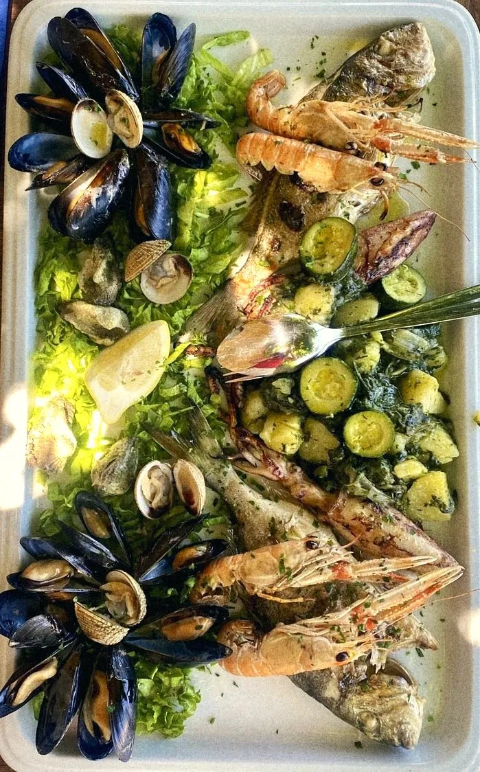 A platter of mussels, clams, langoustines, whole fish and zucchini