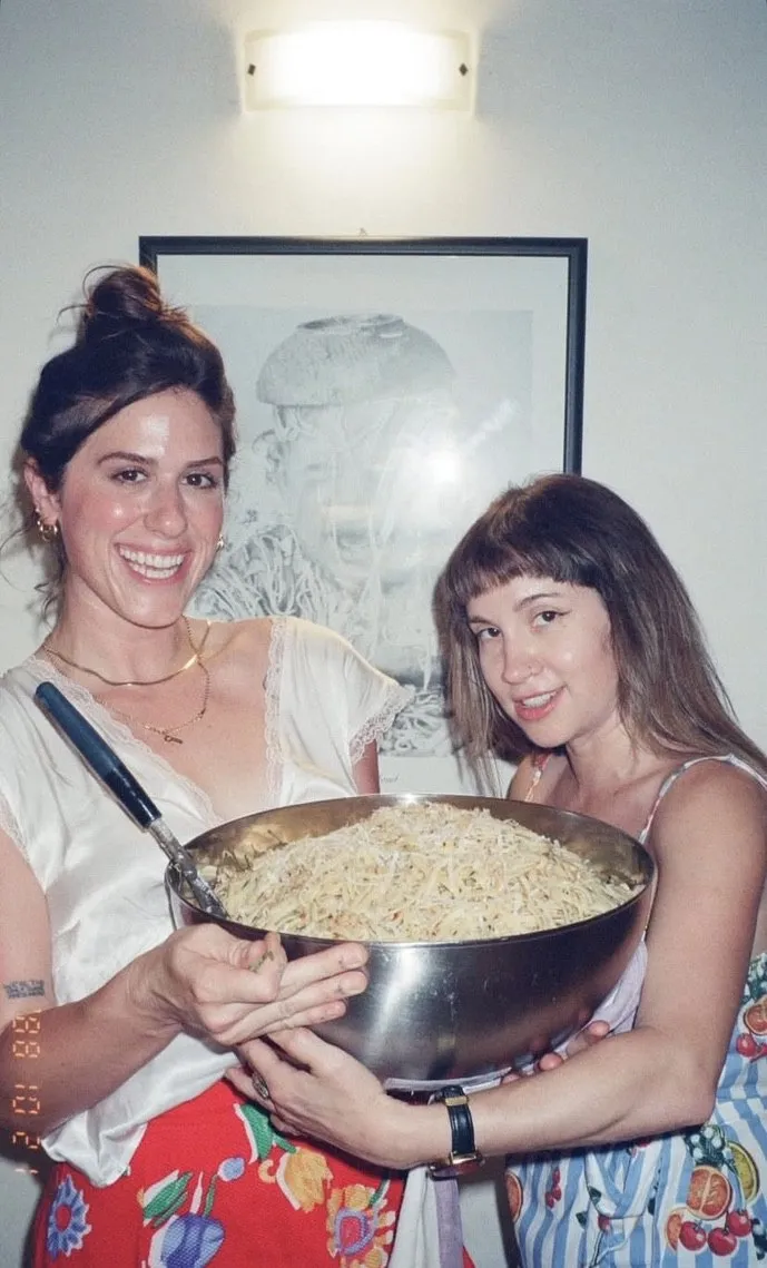 Kristi and Cat holding a giant bowl of pasta